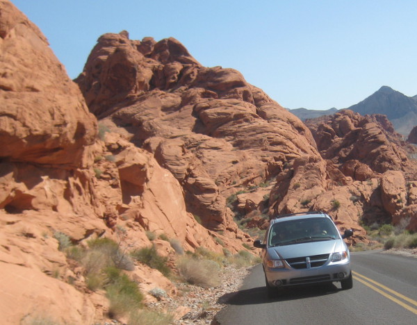 photo of a minivan driving through the Valley of Fire