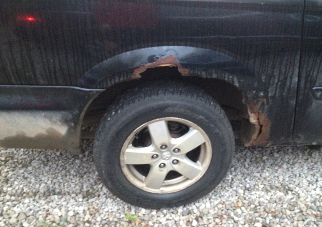 image of minivan with rusty wheel wells