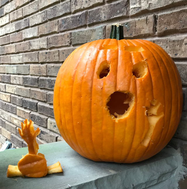 image of some carved pumpkin jack-o-lanterns during the day