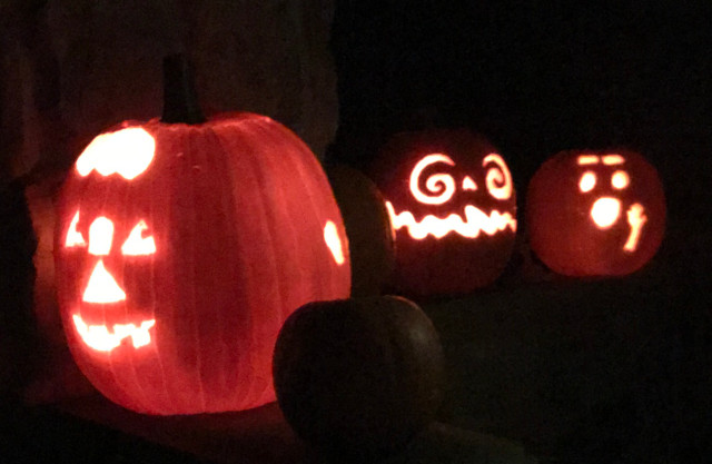 image of some carved pumpkin jack-o-lanterns during the night