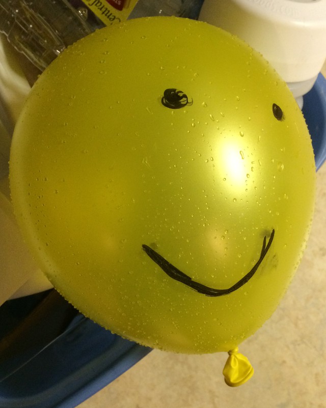 image of a face drawn on a balloon with marker