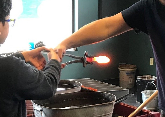 image of a forge and anvil setup, about to plunge a hot dagger into water