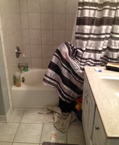 image of a child playing hide and seek in a shower curtain