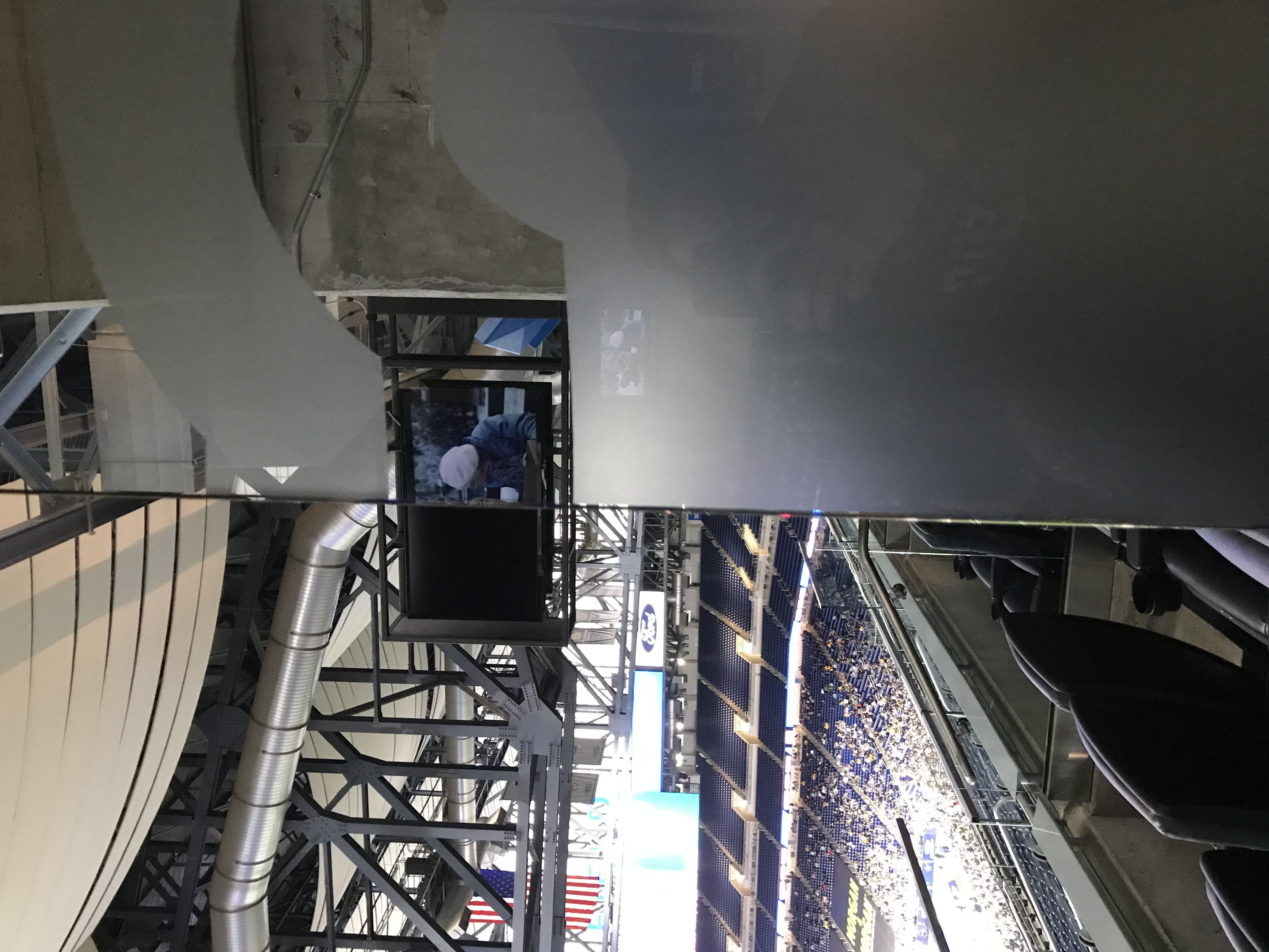 image of the Terrace Suites at Ford Field, showing a TV screen through the glass divider