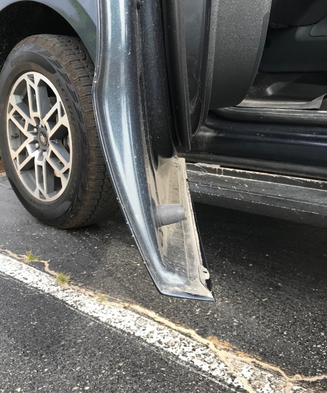 image of a car door with a curved section that protrudes with a sharp edge