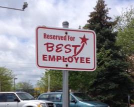 image of an empty parking spot with a sign saying it is reserved for the best employee