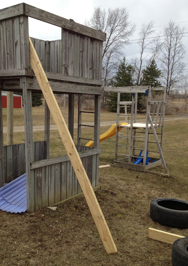 image of old tires along some board to measure as a ladder