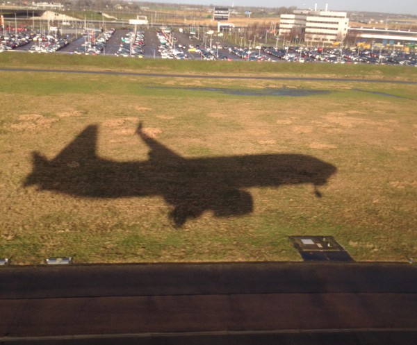 photo of an airplane about to land, from the airplane window