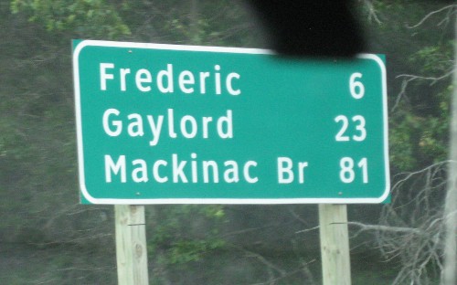road sign showing the distance to the Mackinac Bridge