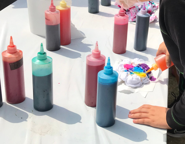 image of someone tie dyeing a T shirt