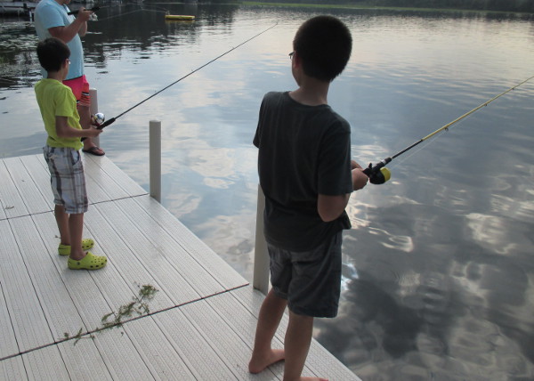 photo of boys fishing off a dock