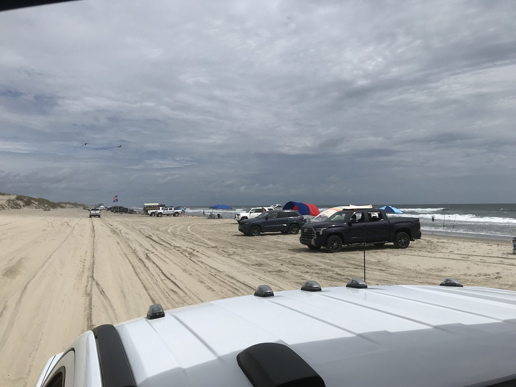image of the beach with trucks parked along it in Corolla North Carolina